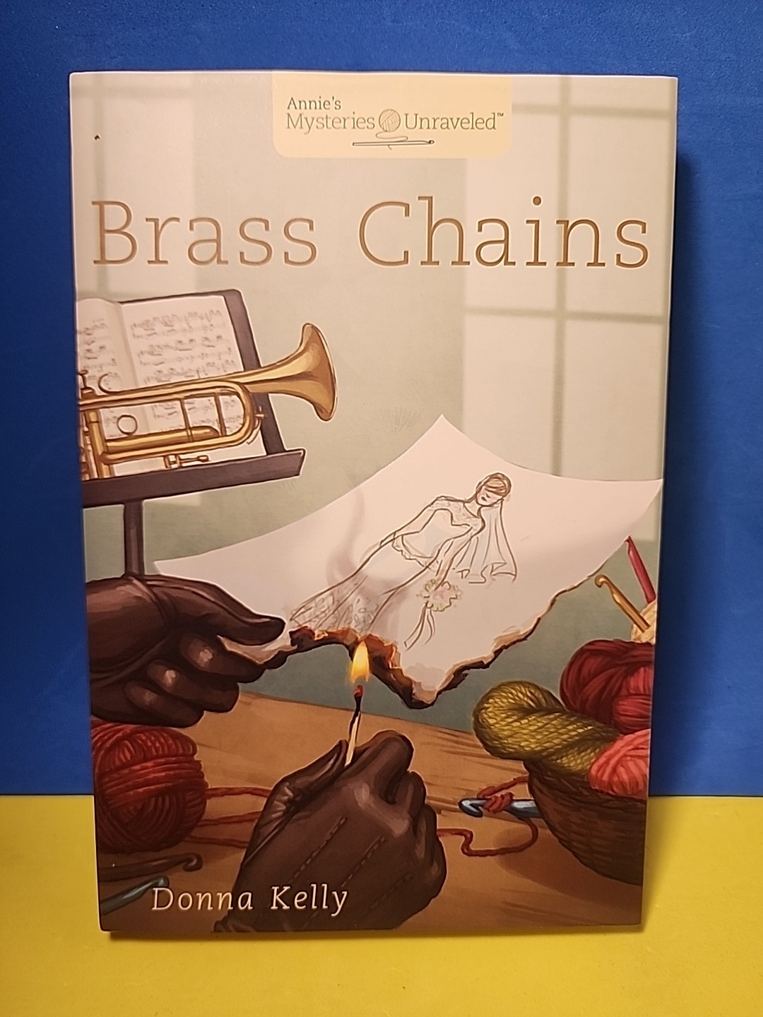 Annie’s Mysteries Unraveled – Brass Chains by Donna Kelly HC 2015