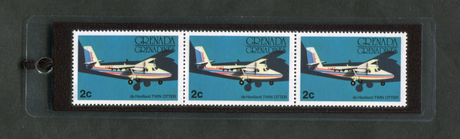1976 GRENADA – TWIN OTTER, LAMINATED BOOKMARK W/REAL POSTAGE STAMPS #184.